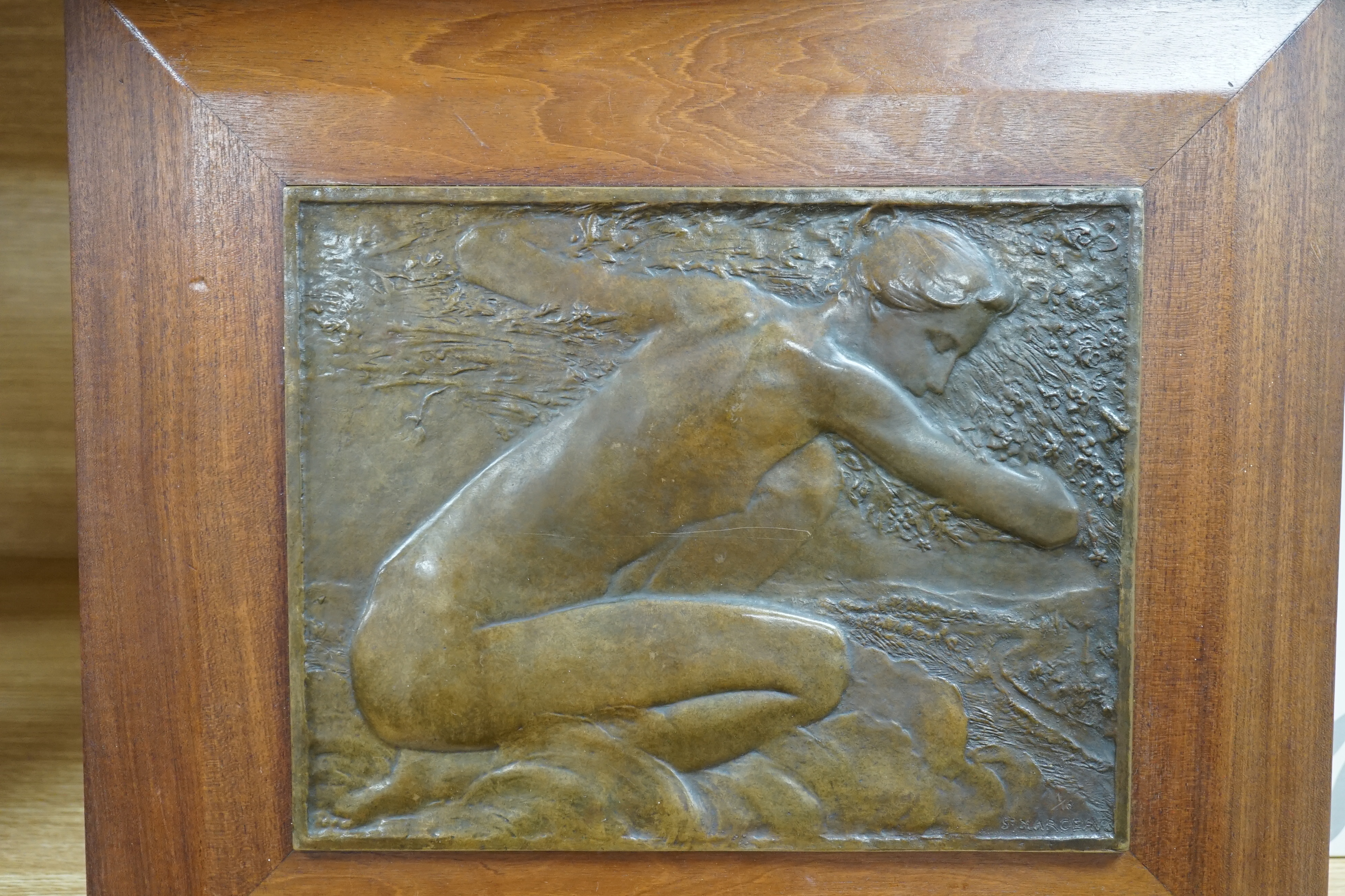 A framed bronze plaque of a kneeling figure, signed lower right, St. Marceau, limited edition 1/10, 31cm high. Condition - good